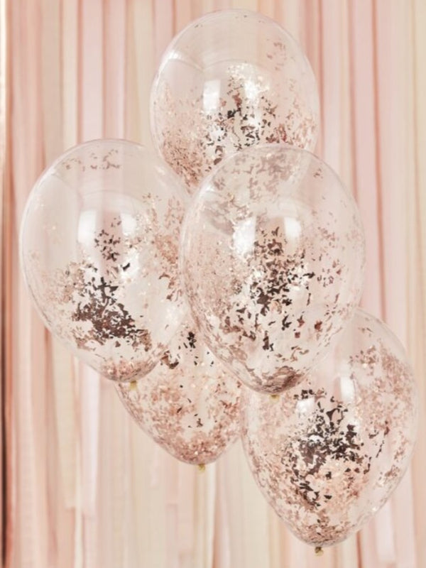 Transparent coloured balloons with rose gold confetti inside 