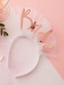 headband with bride in rose gold on top with veil attached